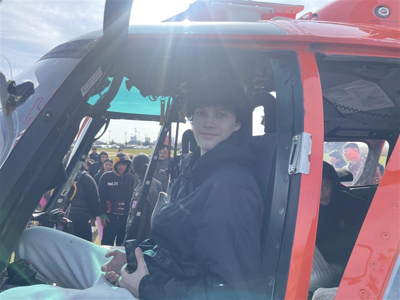 Atlantic City High School student Collin Clyde sits in Coast Guard helicopter.
